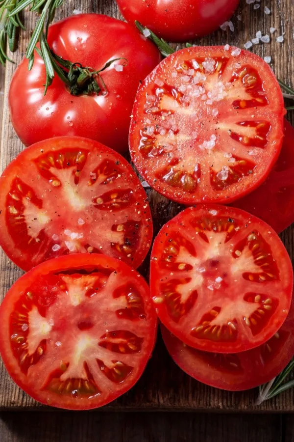 Sliced tomatoes on a wooden board